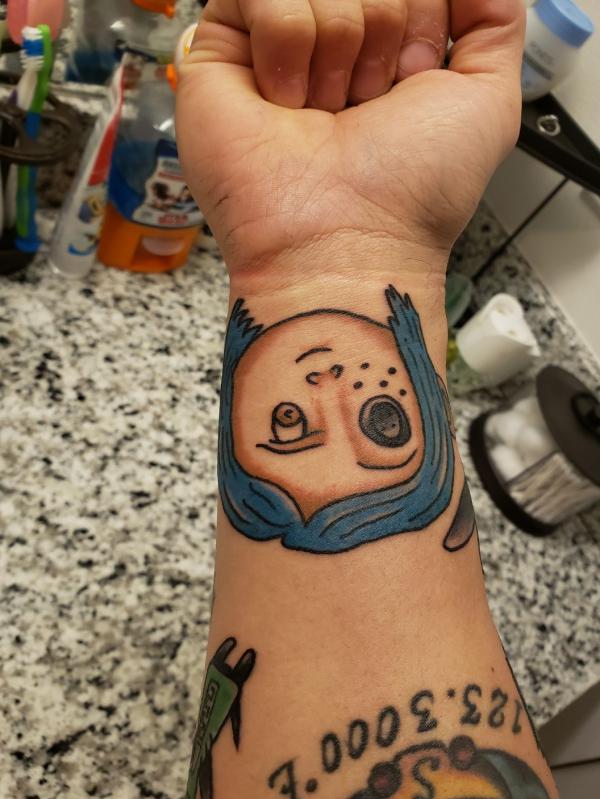 Coraline face wrist tattoo