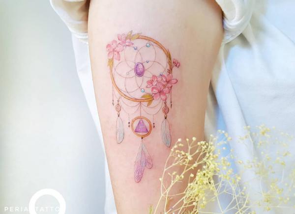 Feminine dream catcher adorned with cherry blossoms on the wheel