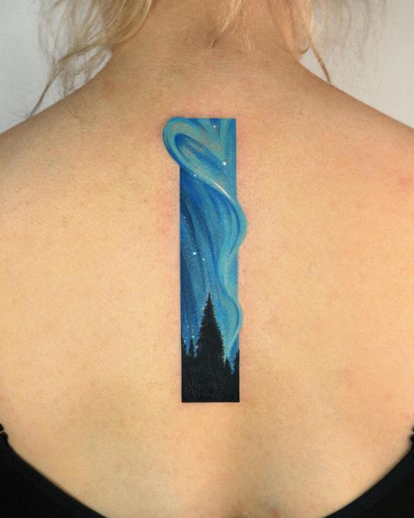 Forest and galaxy spine tattoo