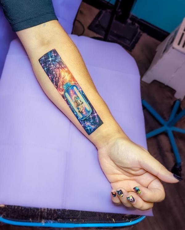 Galaxy and a bottle with an astronaut inside