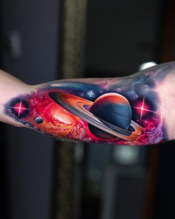 Galaxy and spinning planet bicep tattoo