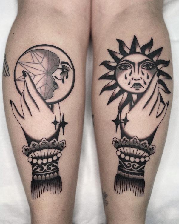 Hands holding sun and moon faces