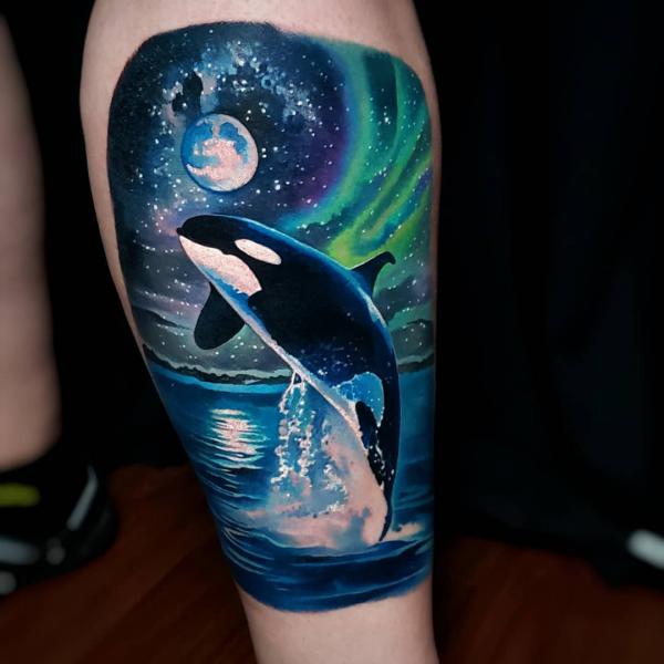 Jumping whale and galaxy tattoo