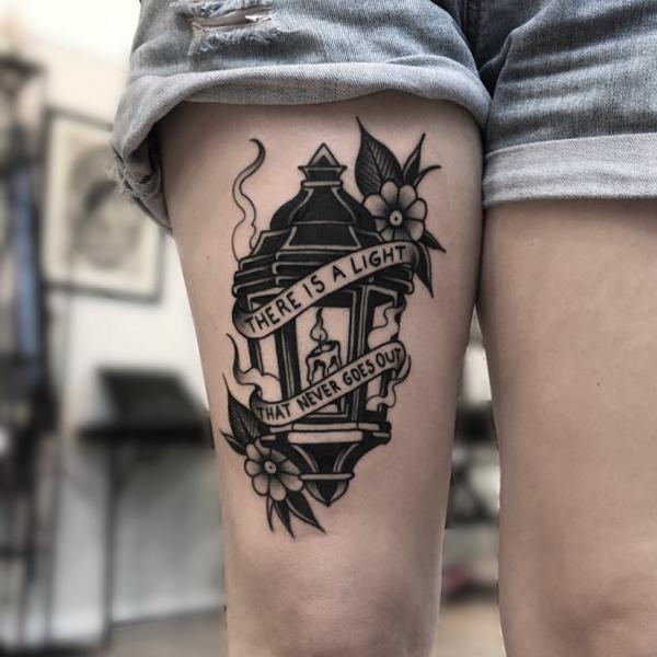 Lamp with banner bearing words There is a light That never goes out