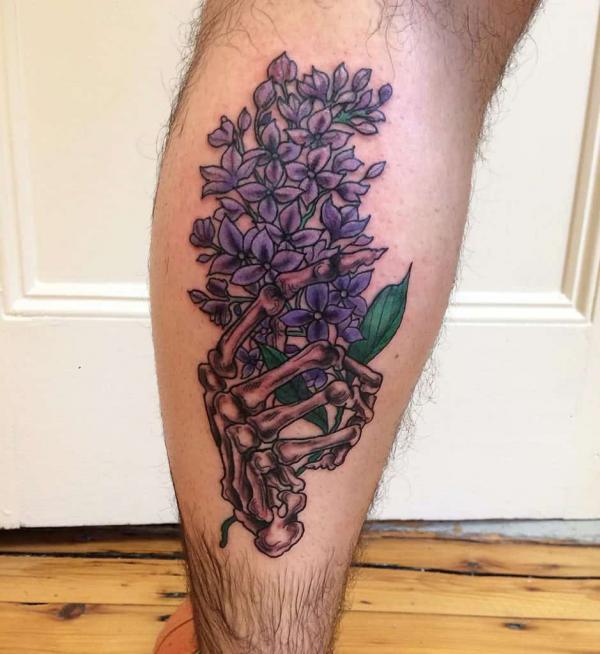 Lilac and skeleton hand tattoo