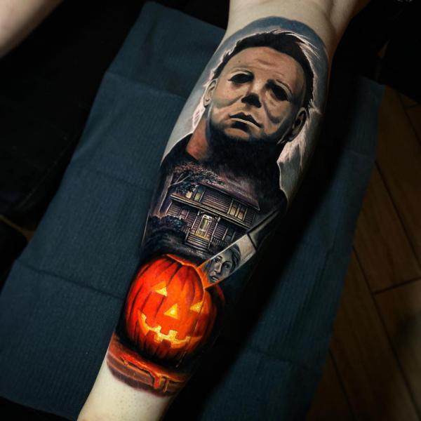 Michael Myers and house and a knife pierced a pumpkin tattoo