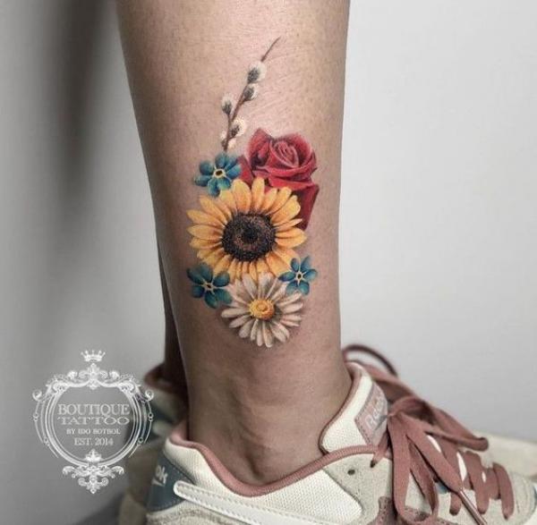 Realistic rose and sunflower with daisy tattoo on lower leg