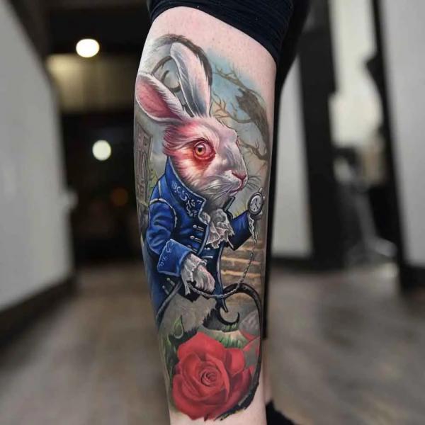 Realistic white rabbit and rose tattoo