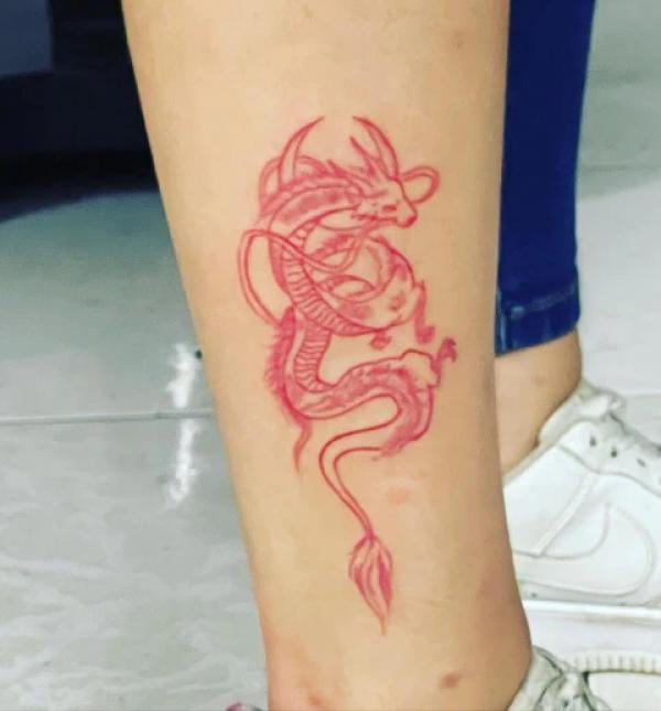 Red dragon lower leg tattoo