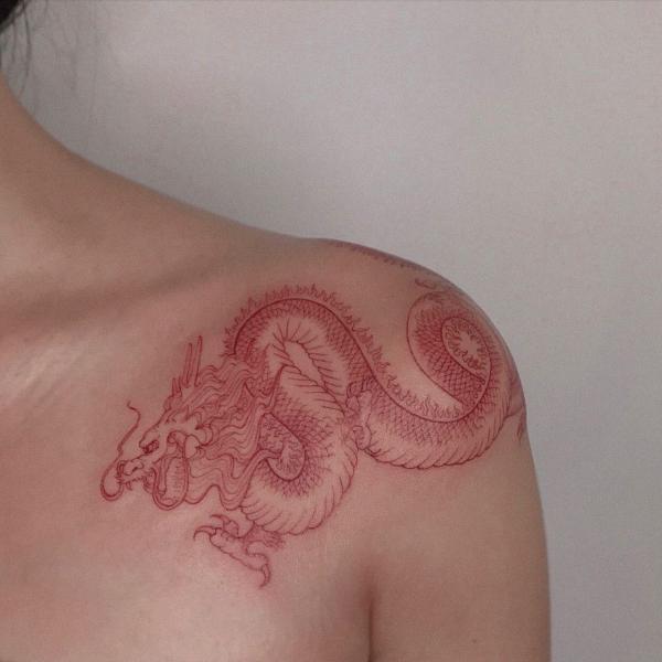 Red dragon tattoo below clavicle
