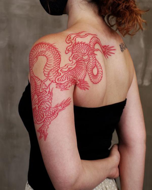 Red dragon tattoo from arm to shoulder blade