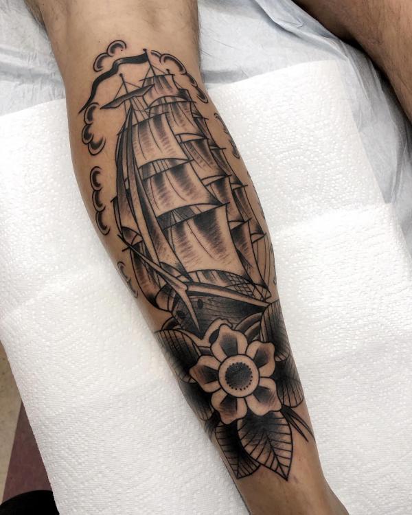 Sailing boat with flower calf tattoo