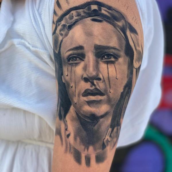 Tearing Virgin Mary tattoo