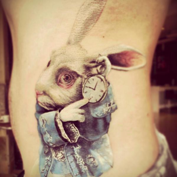 The white rabbit with a clock side tattoo