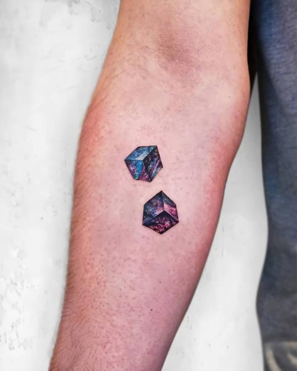 Two galaxy cubes tattoo on forearm