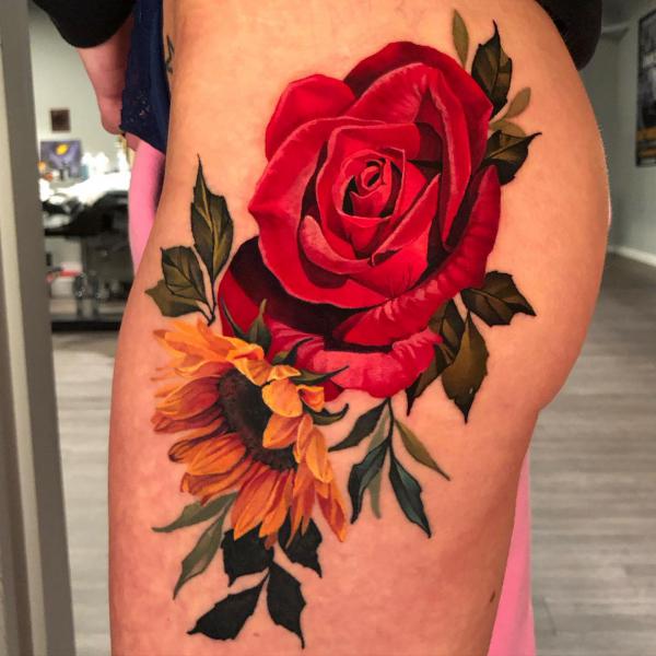 Vibrant red rose and yellow sunflower tattoo