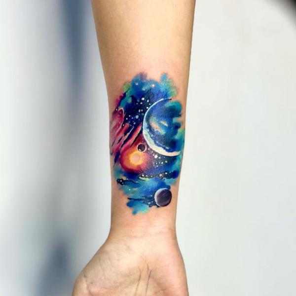 Watercolor galaxy wrist tattoo