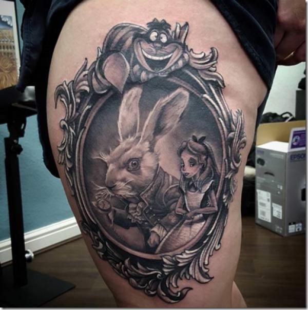 White rabbit and Alice picture frame tattoo thigh