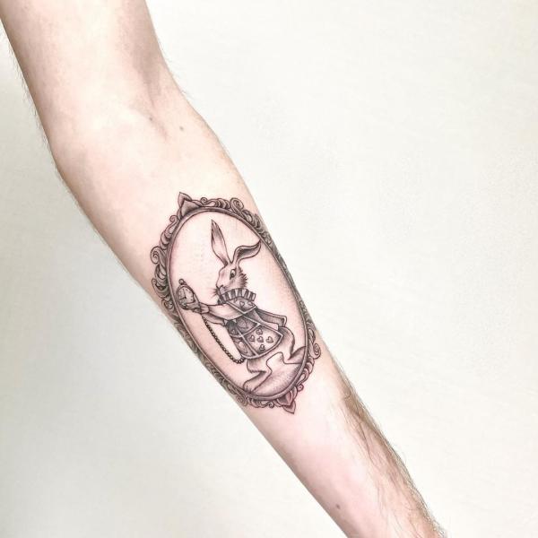 White rabbit photo frame tattoo on arm