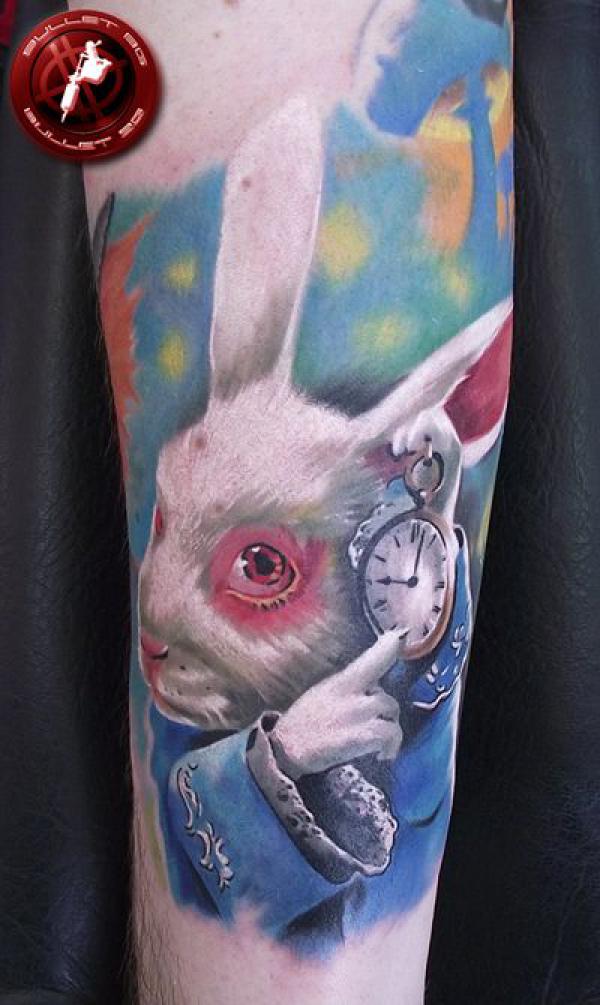 White rabbit with a clock arm tattoo