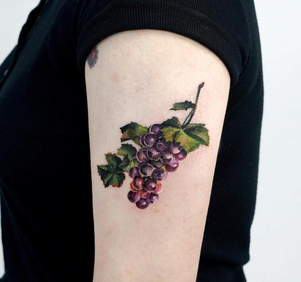 A bunch of grapes upper arm tattoo