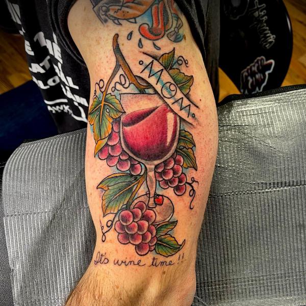 A cup of red wine and grapes tattoo for Mom with words Its wine time