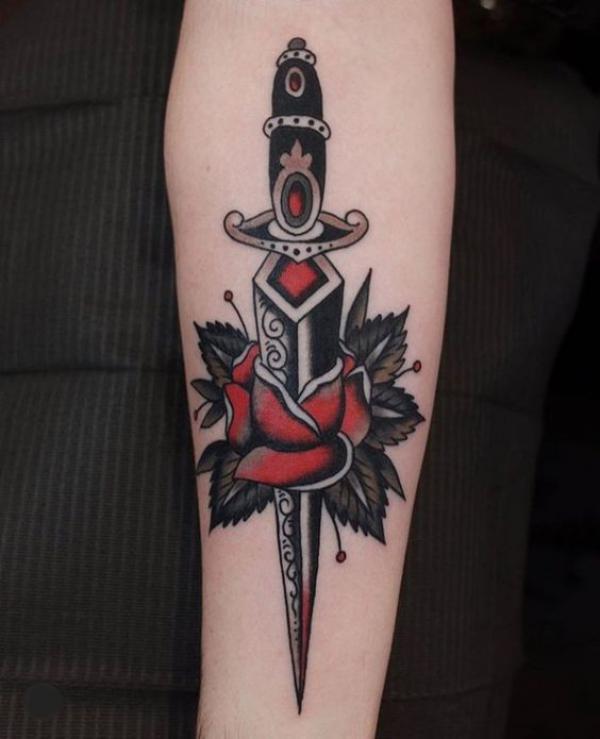 A dagger pierced a rose with leaves
