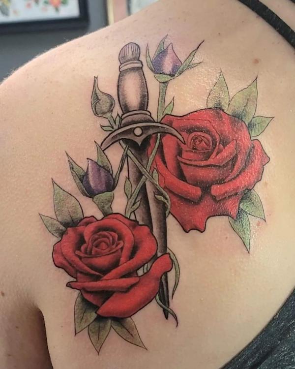 A dagger with two red rose tattoo