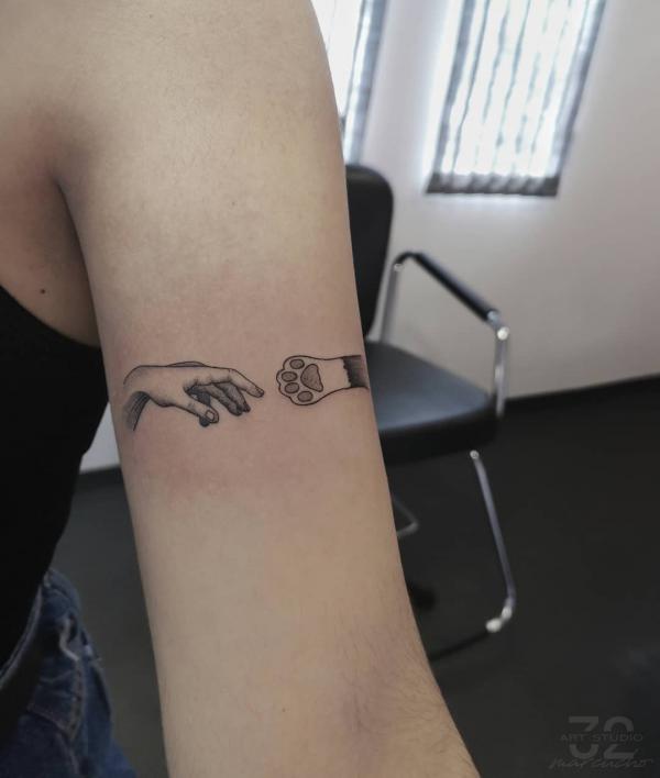 A hand point to a fist with paw print