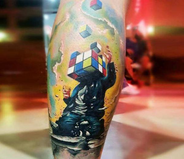 A man in a suit with a head of rubix cube