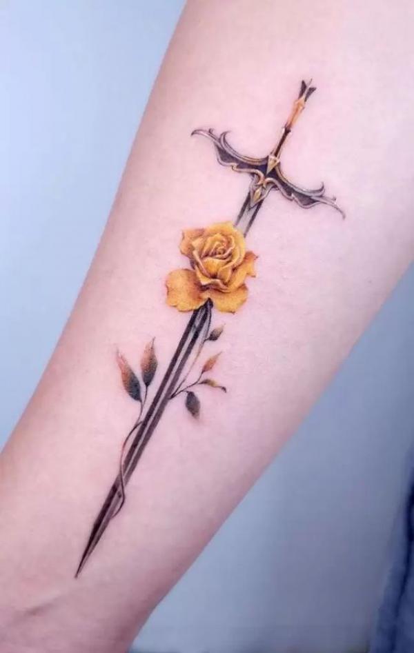 A sword with a yellow rose tattoo
