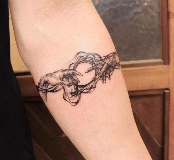 Adam hands and sun with swirls