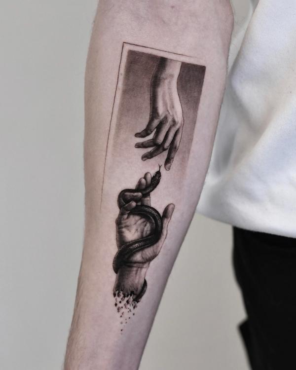 Adam hands with a snake tattoo