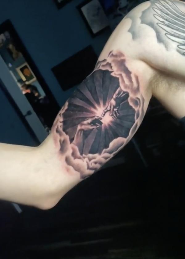 Adam hands with sun and clouds tattoo