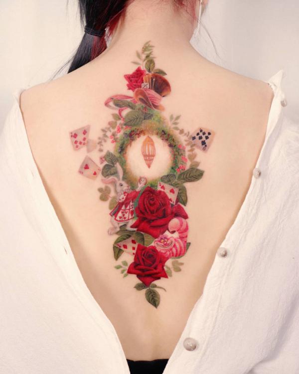 Alice In Wonderland tattoo with white rabbit caterpillar and red roses