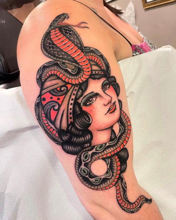 American traditional cobra wrapped around a female half sleeve tattoo
