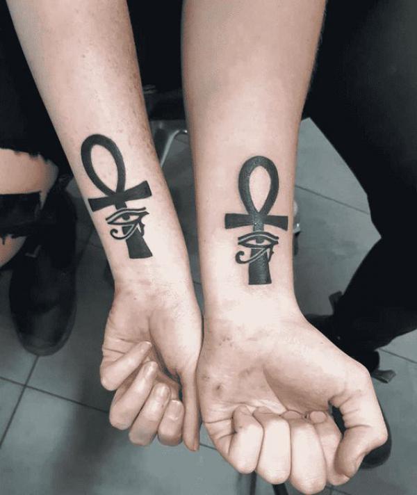 Ankh cross and eye of Ra matching tattoo