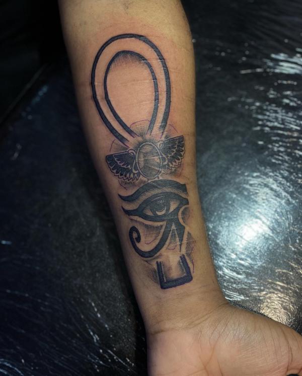 Ankh with a scarab beetle and eye of Ra tattoo