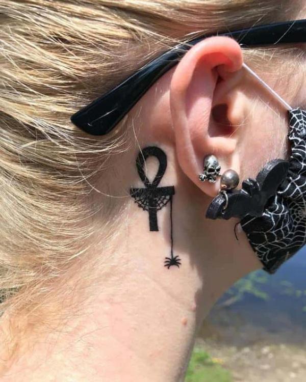Ankh with spider web and a spider tattoo behind ear