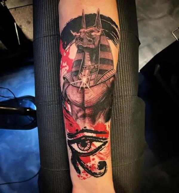 Anubis and watercolor Eye of Horus tattoo
