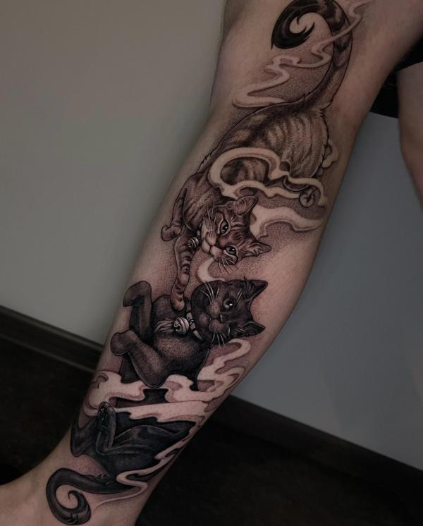 Black and grey cats leg tattoo