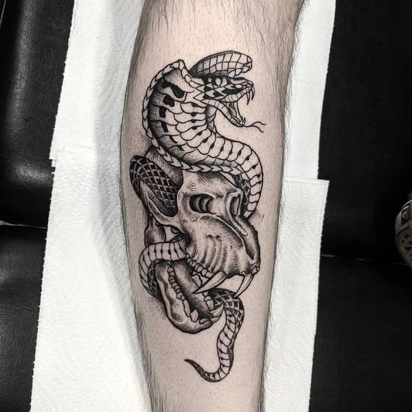 Black and grey cobra and animal skull tattoo