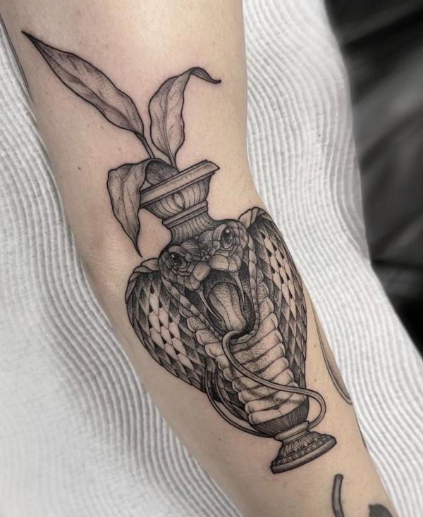 Black and grey cobra vase tattoo