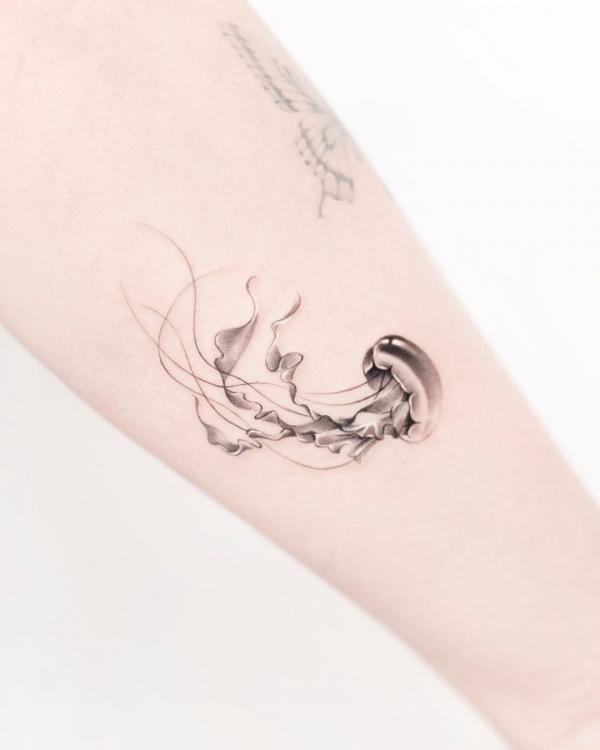 Black and grey dainty jellyfish tattoo