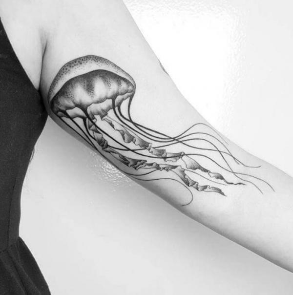 Black and grey jellyfish bicep tattoo