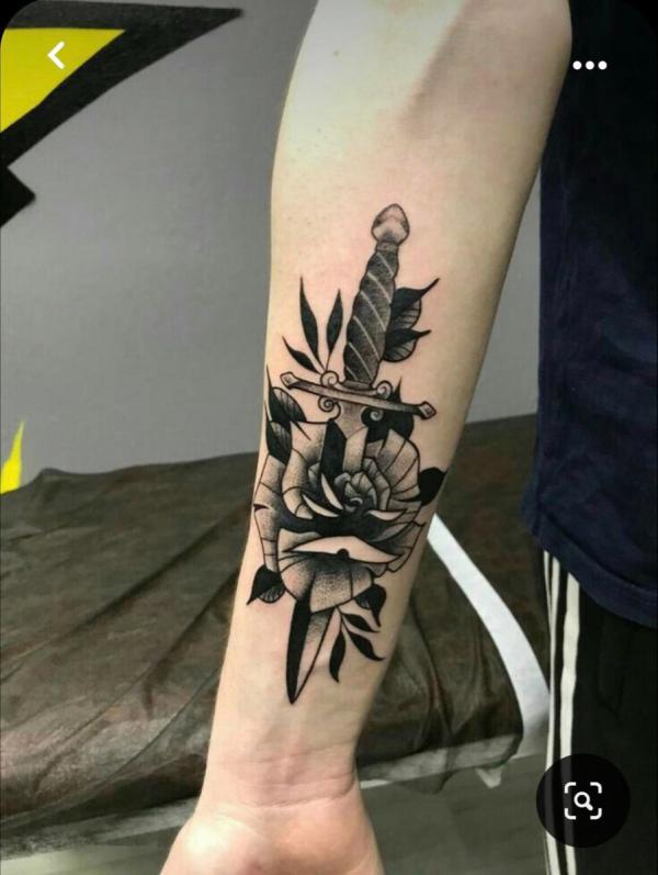 Black and grey rose and dagger tattoo