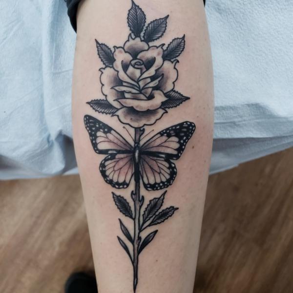 Black and grey rose with stem and butterfly tattoo
