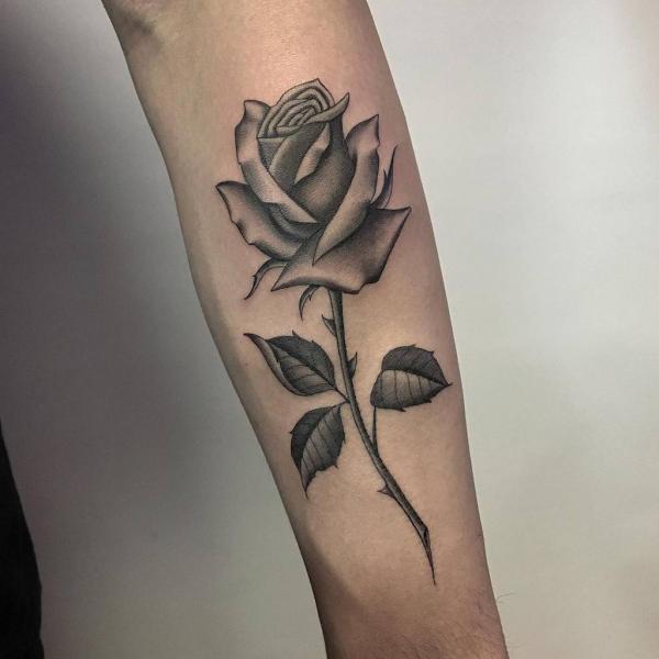 Black and grey rose with stem forearm tattoo