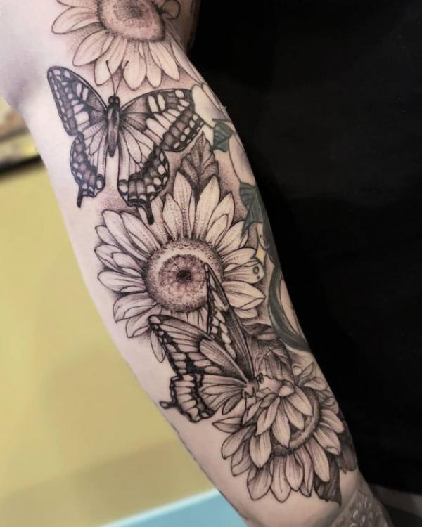 Black and grey sunflower and monarch butterfly tattoo