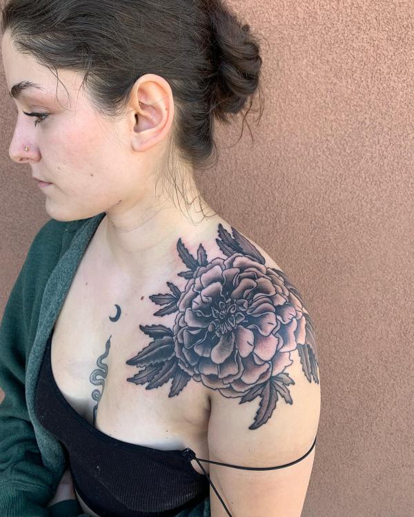 Black and white marigold shoulder tattoo for women